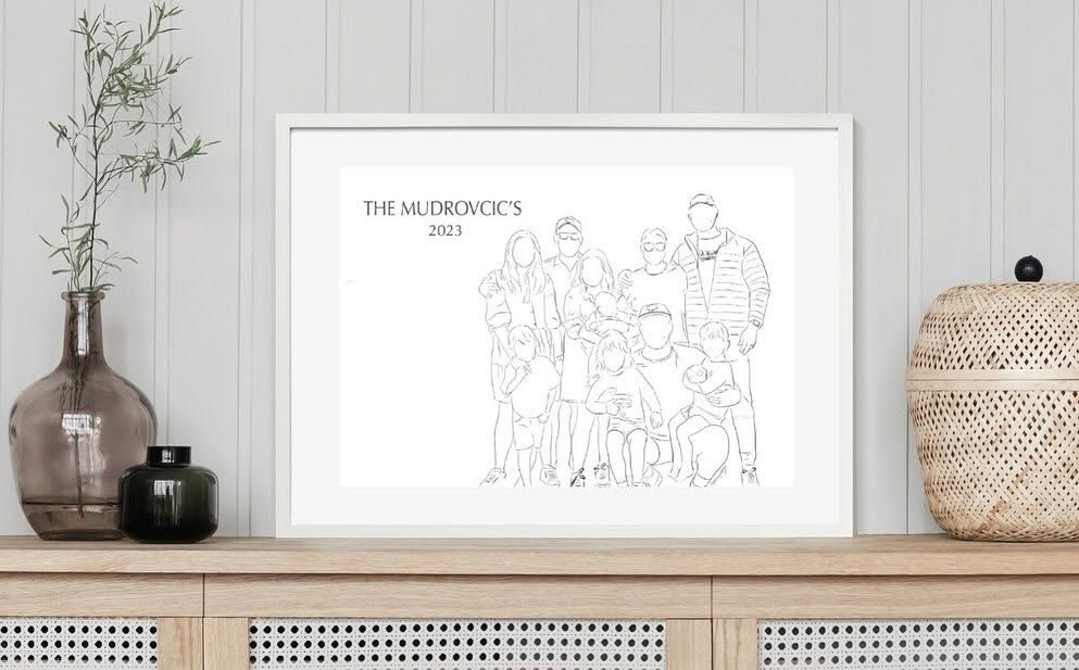The Mudrovcic family drawing framed on a sideboard beside a vase